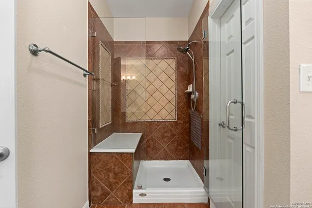 a bathroom with a shower and a sink