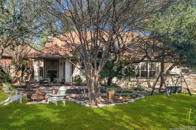a view of a house with backyard porch and sitting area