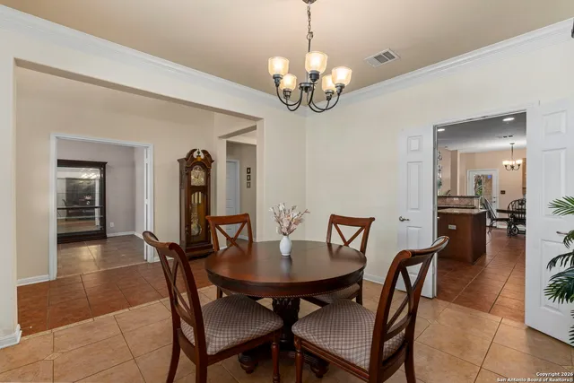 a view of a dining room with furniture and chandelier