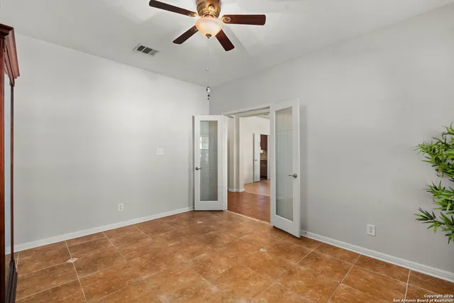 a view of a livingroom with a ceiling fan and entryway