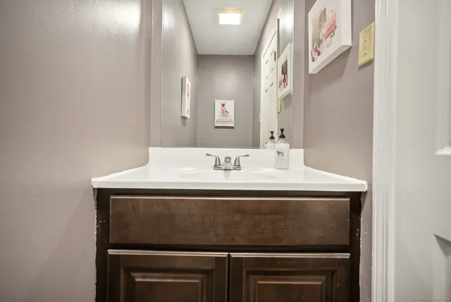 a bedroom with a bed a rug with dresser and mirror