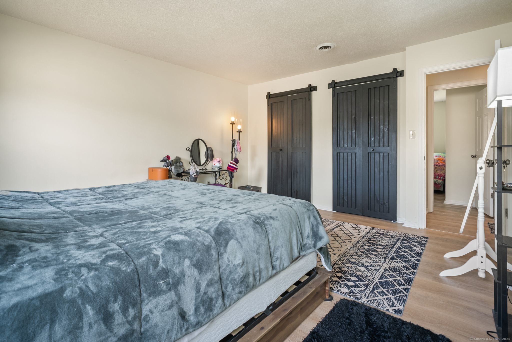 246 Reeds Gap Road, Unit 1D North Branford, CT 06472 - Photo 20 of 35 a bed sitting in a bedroom and mirror