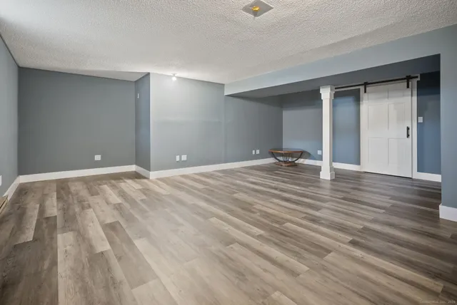 a view of a room with wooden floor