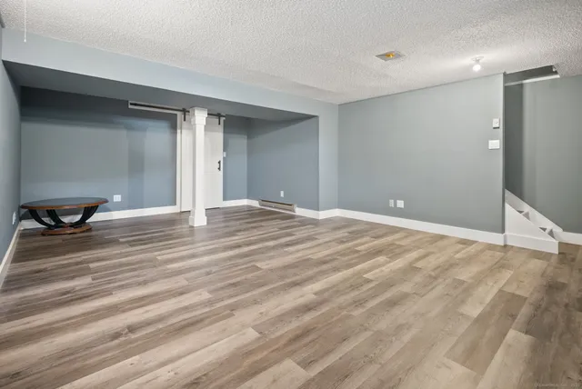 a view of room with wooden floor