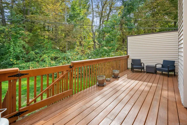 a view of a roof deck with wooden floor and fence