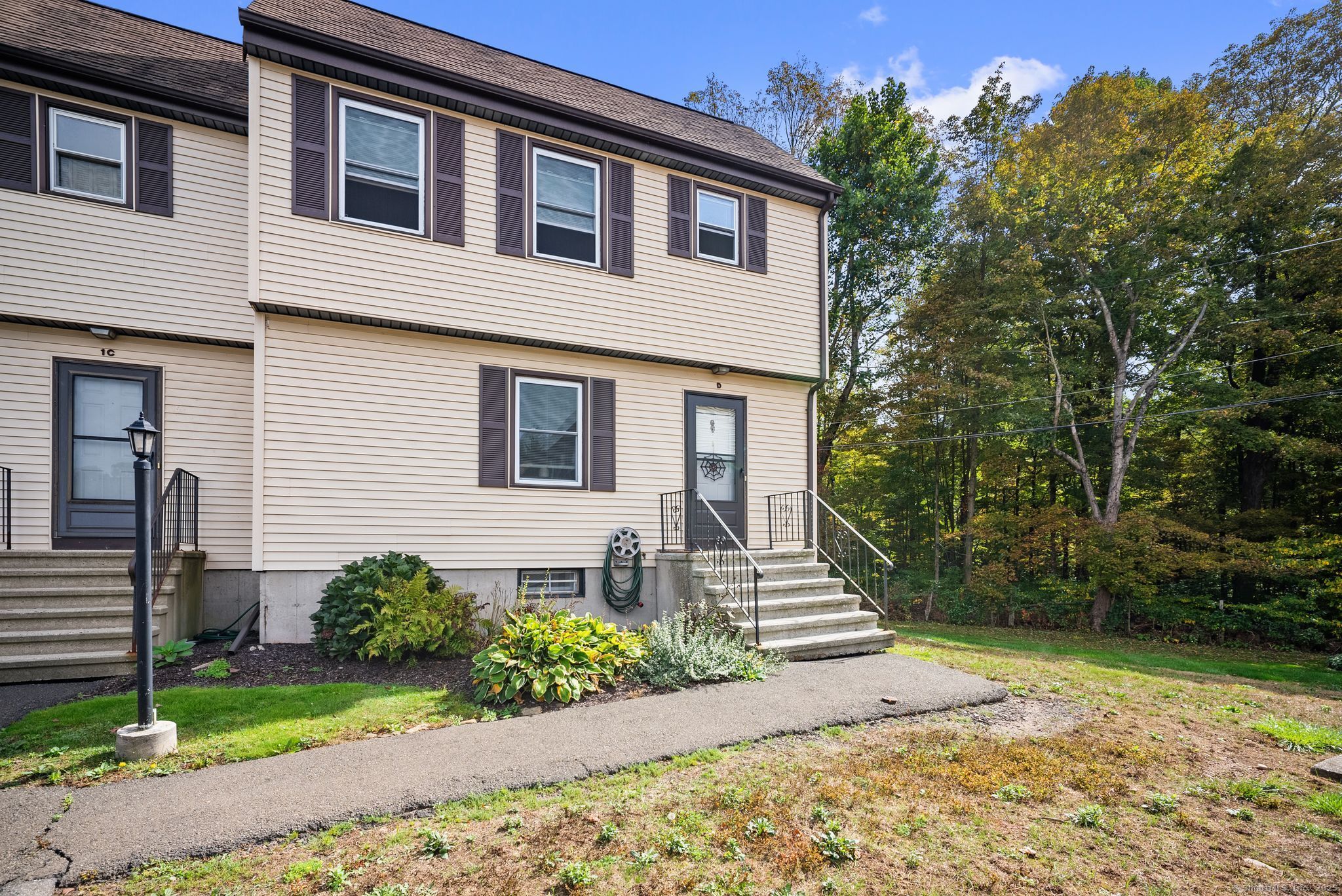 246 Reeds Gap Road, Unit 1D North Branford, CT 06472 - Photo 3 of 35 a front view of a house with garden