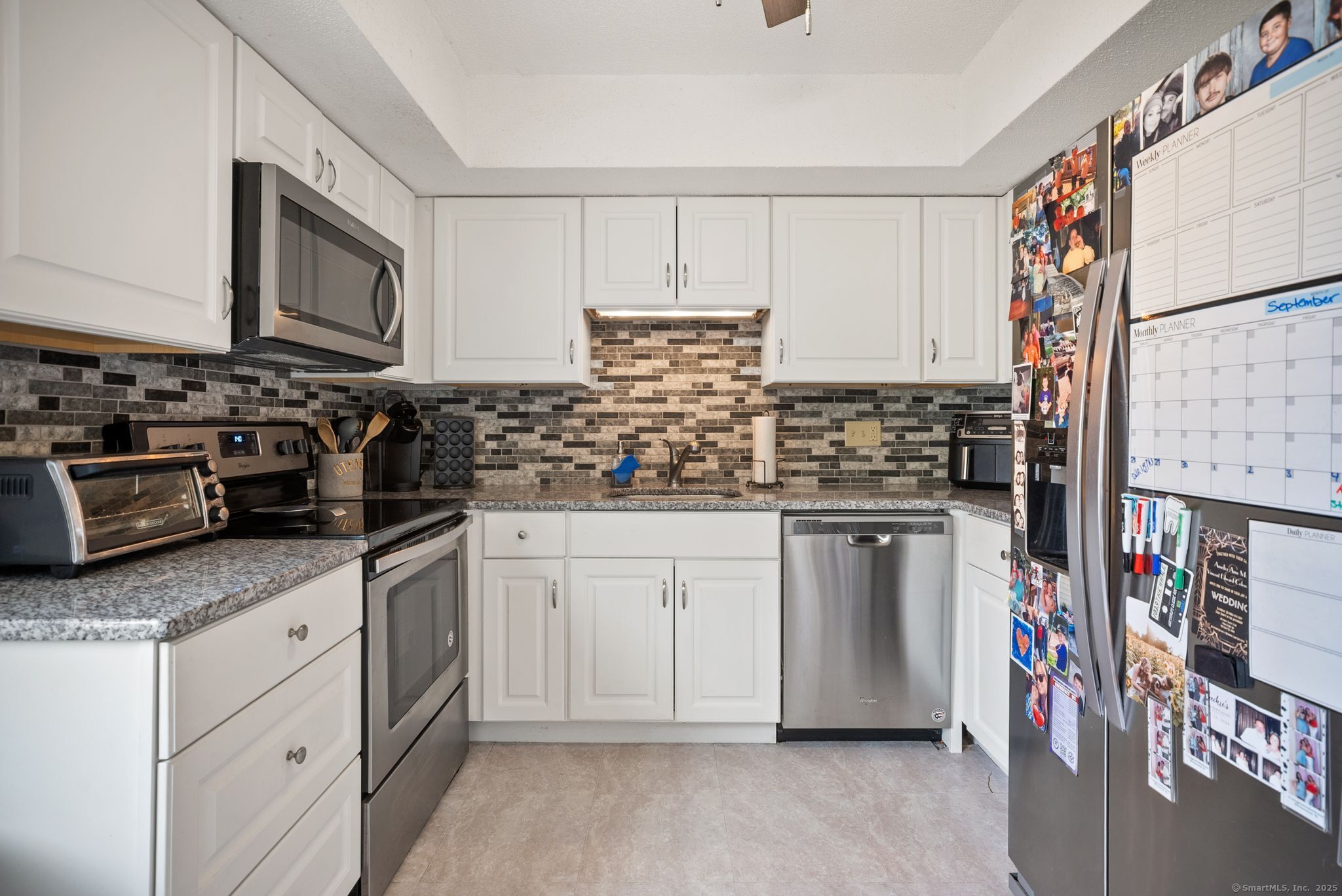 246 Reeds Gap Road, Unit 1D North Branford, CT 06472 - Photo 6 of 35 a kitchen with stainless steel appliances granite countertop a stove and a sink