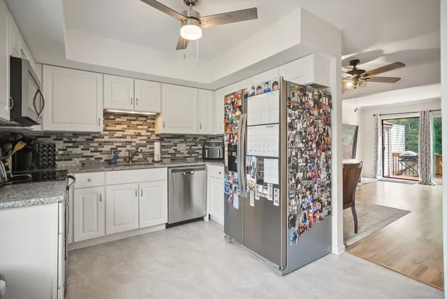 a kitchen with refrigerator and cabinets
