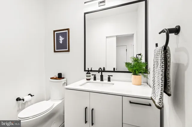a bathroom with a sink toilet and mirror