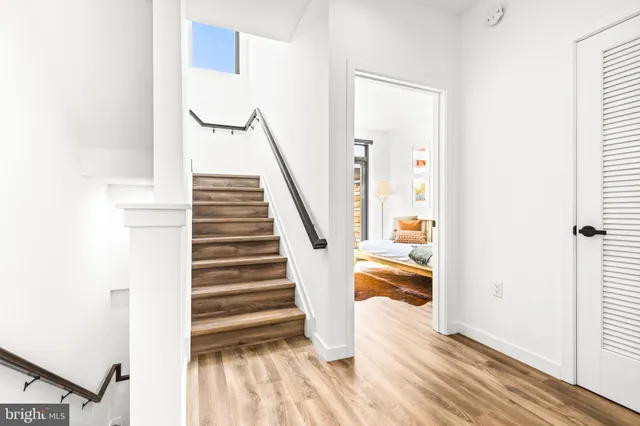 a view of entryway and hall with wooden floor