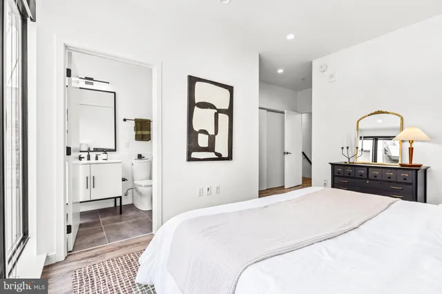 a bedroom with a bed and a view of living room