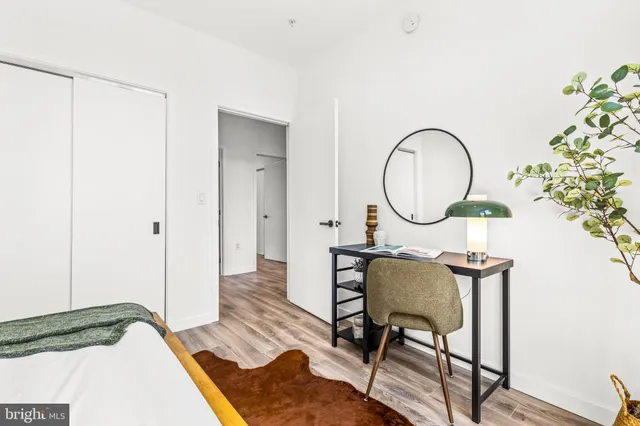 a living room with furniture and a mirror