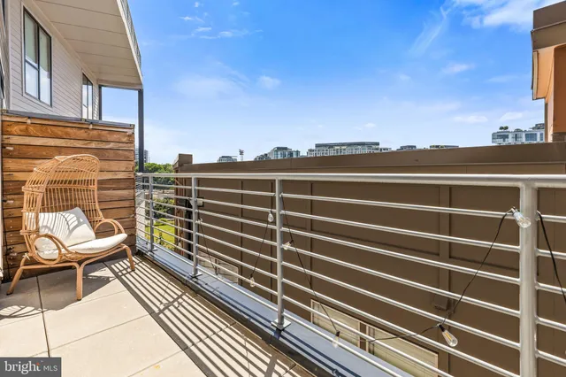 a view of a balcony with a chair and wooden floor