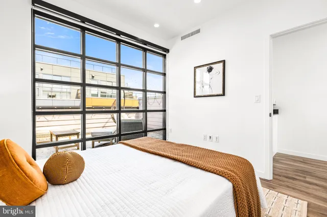 a bedroom with a large bed and a large window