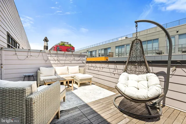 a living room with furniture a table and wooden floor