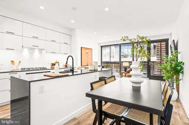 a kitchen with a table and chairs