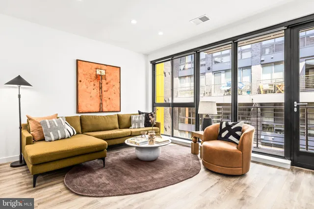 a living room with furniture and a large window