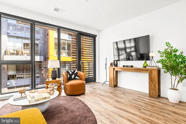 a living room with furniture fireplace and flat screen tv