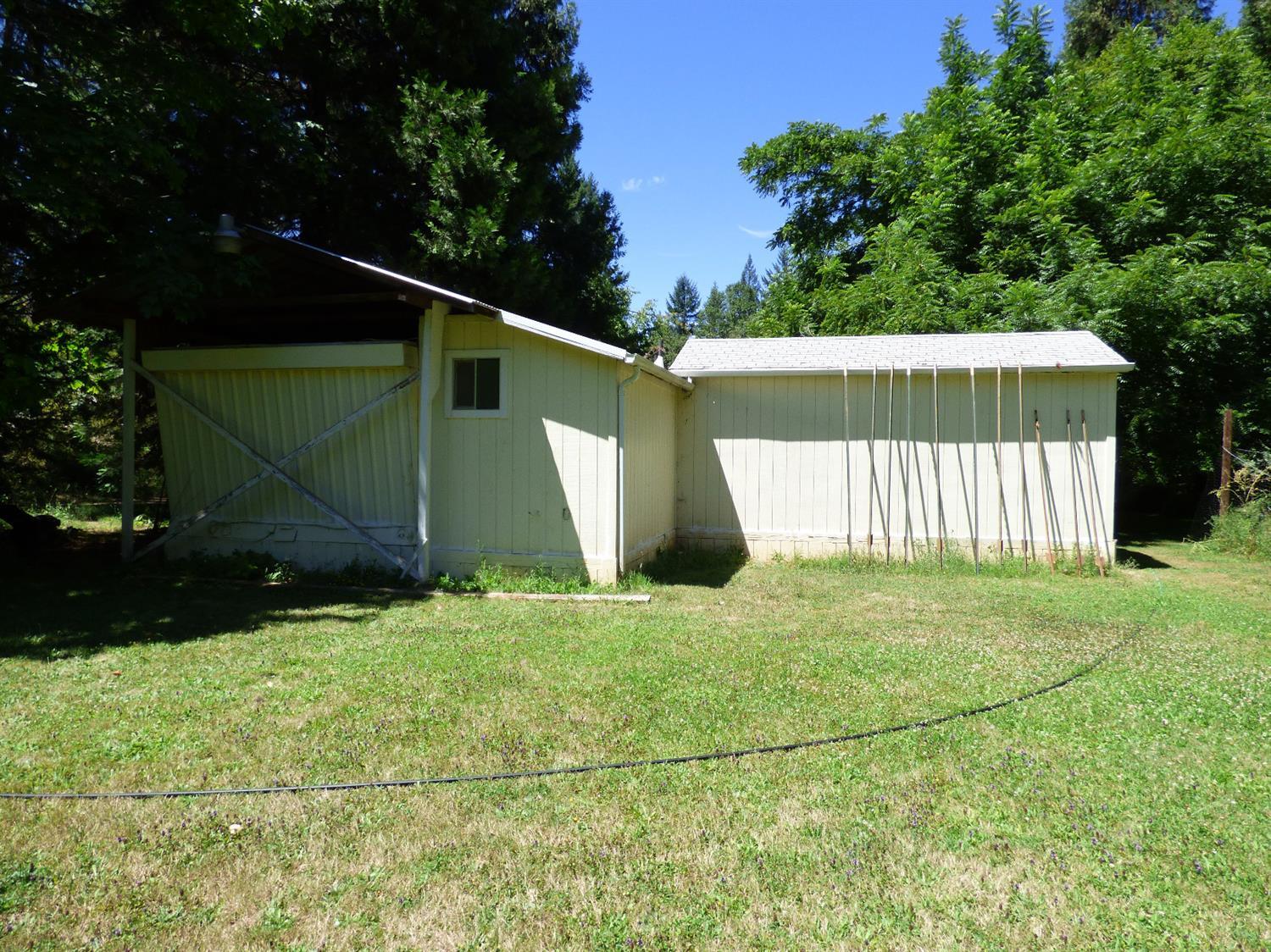 680 Hays Cut Off Road Cave Junction, OR 97523 - Photo 25 of 28 back of manufactured home and stick buil