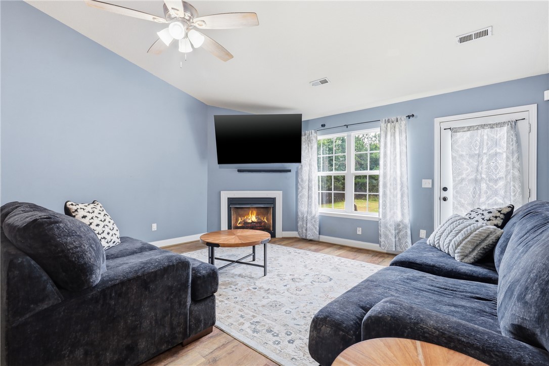 105 Lacy Lane Anderson, SC 29621 - Photo 3 of 16 A comforting living space features a cozy fireplace and convenient outdoor access.