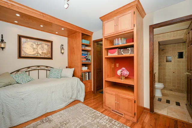 a bedroom with a bed and a painting on the wall