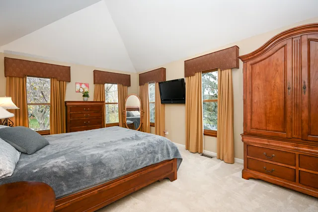 a bedroom with a bed closet and flat tv screen