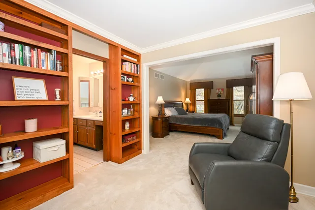 a bedroom with furniture and a book shelf