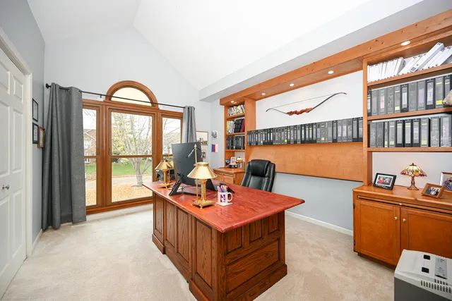 a living room with furniture a fireplace and a large window