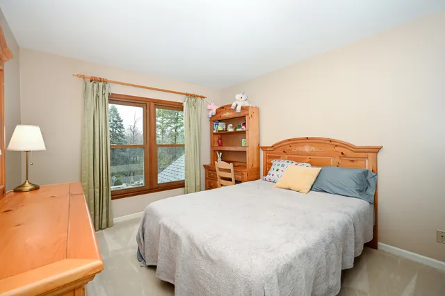 a bedroom with a large bed and a lamp