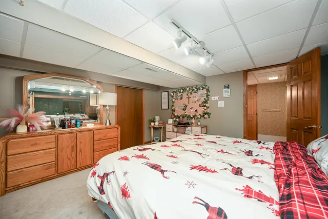 a large bedroom with a bed and a large mirror