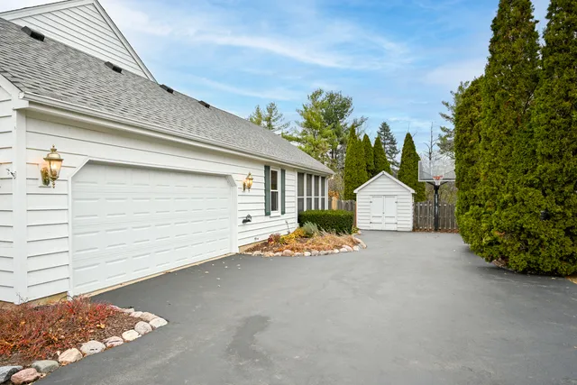 a view of a house with a yard and garage