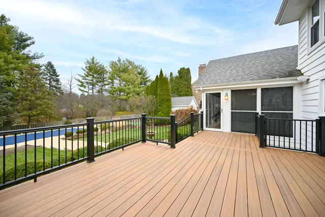 a view of balcony with wooden floor and fence