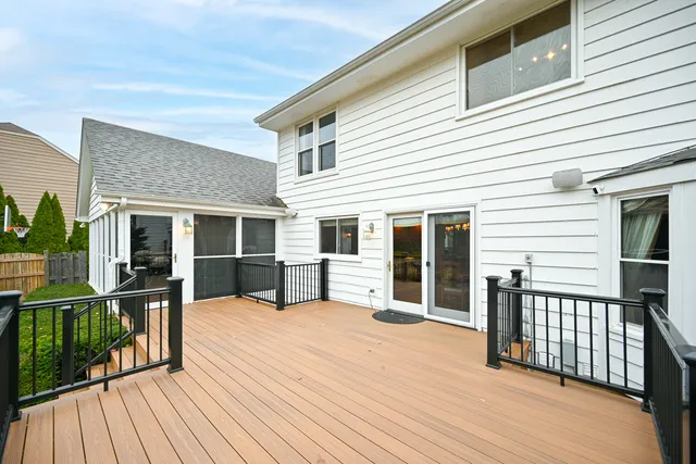 a view of a house with barbeque and wooden floor