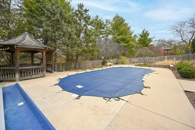 a view of yard with swimming pool and furniture