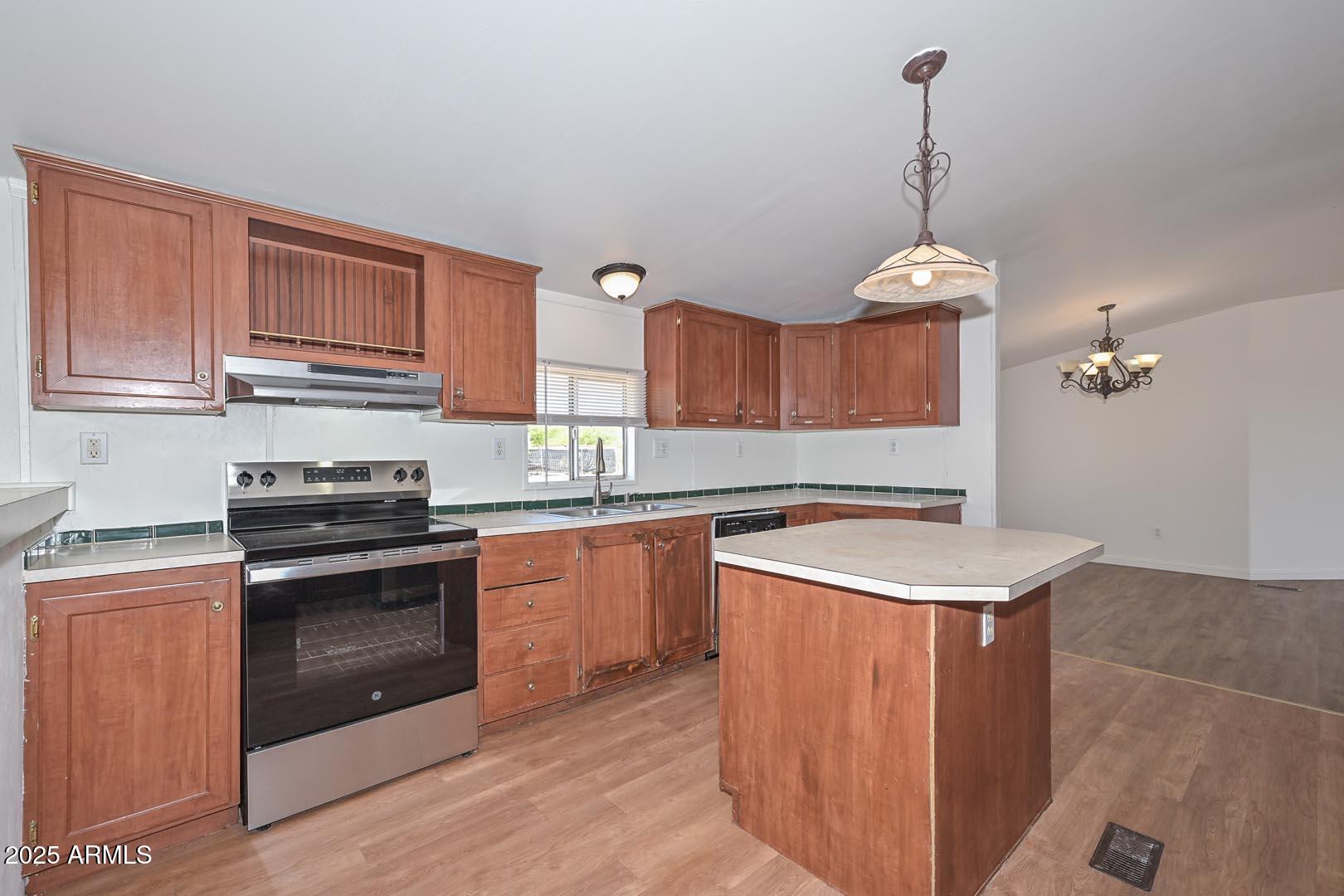 36608 West Lower Buckeye Road Tonopah, AZ 85354 - Photo 13 of 39 a kitchen with stainless steel appliances granite countertop a sink stove and refrigerator