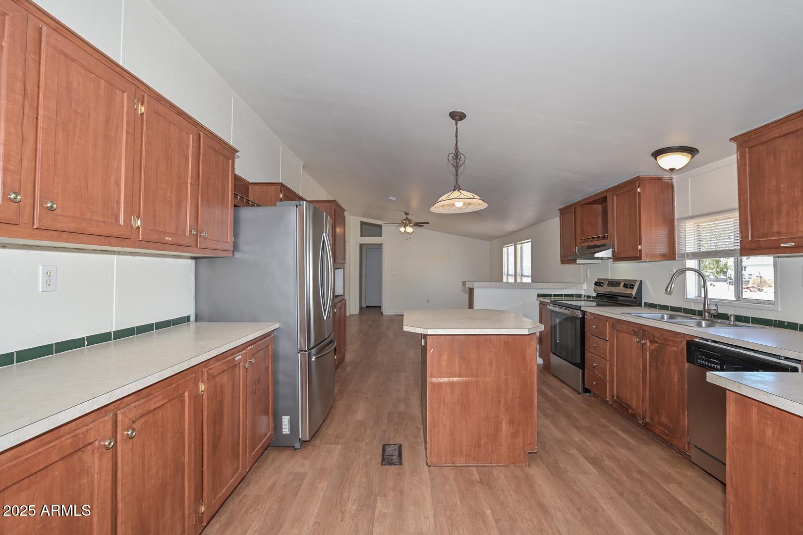36608 West Lower Buckeye Road Tonopah, AZ 85354 - Photo 15 of 39 a kitchen with stainless steel appliances granite countertop a sink stove and refrigerator