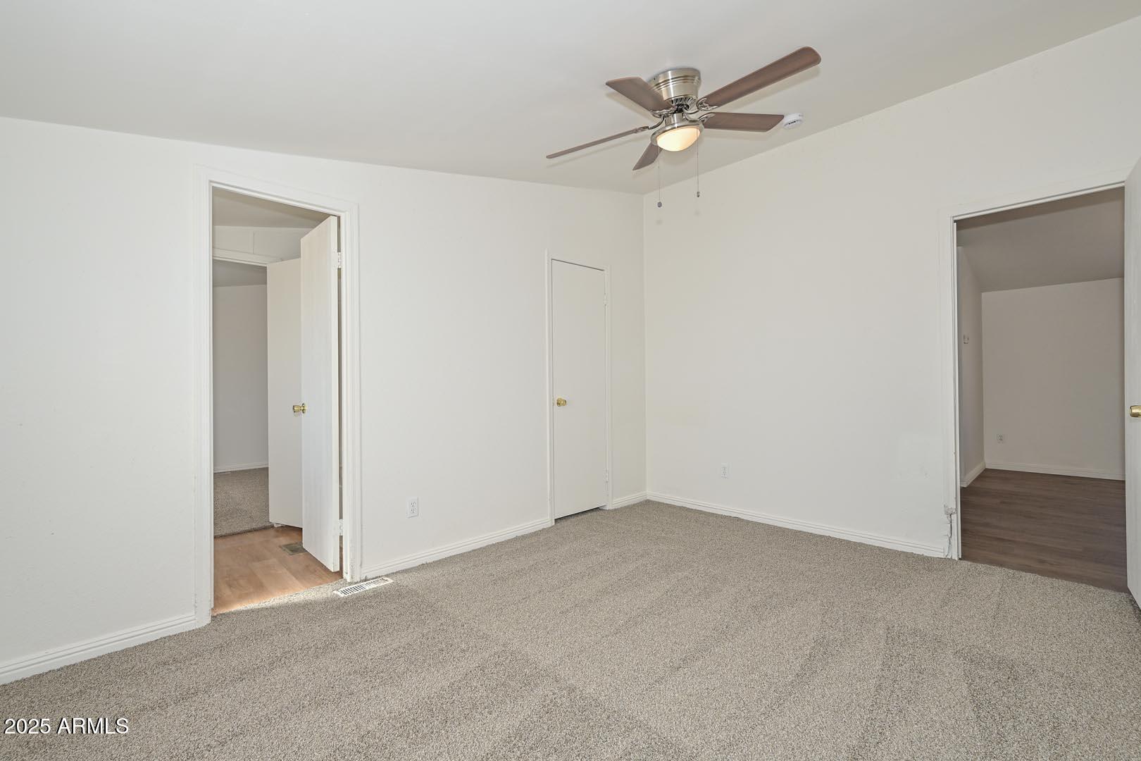 36608 West Lower Buckeye Road Tonopah, AZ 85354 - Photo 27 of 39 an empty room with a ceiling fan and a window