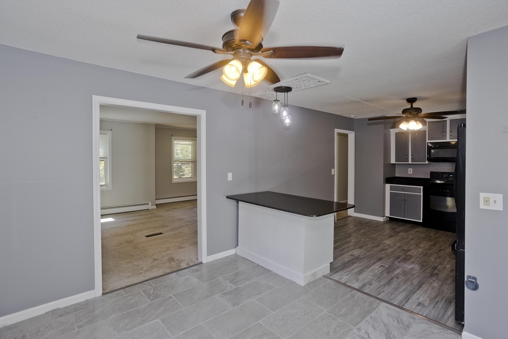 5 Michael Drive Enfield, CT 06082 - Photo 11 of 38 a kitchen with stainless steel appliances kitchen island granite countertop a refrigerator and a sink