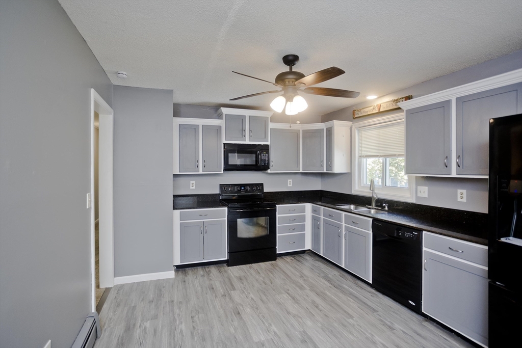 5 Michael Drive Enfield, CT 06082 - Photo 13 of 38 a kitchen with a white cabinets and stainless steel appliances