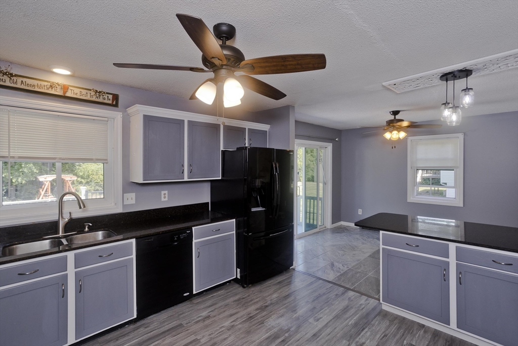 5 Michael Drive Enfield, CT 06082 - Photo 16 of 38 a kitchen with granite countertop a refrigerator a sink and dishwasher