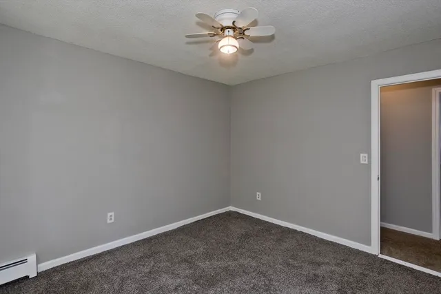 an empty room with a fan and a fan