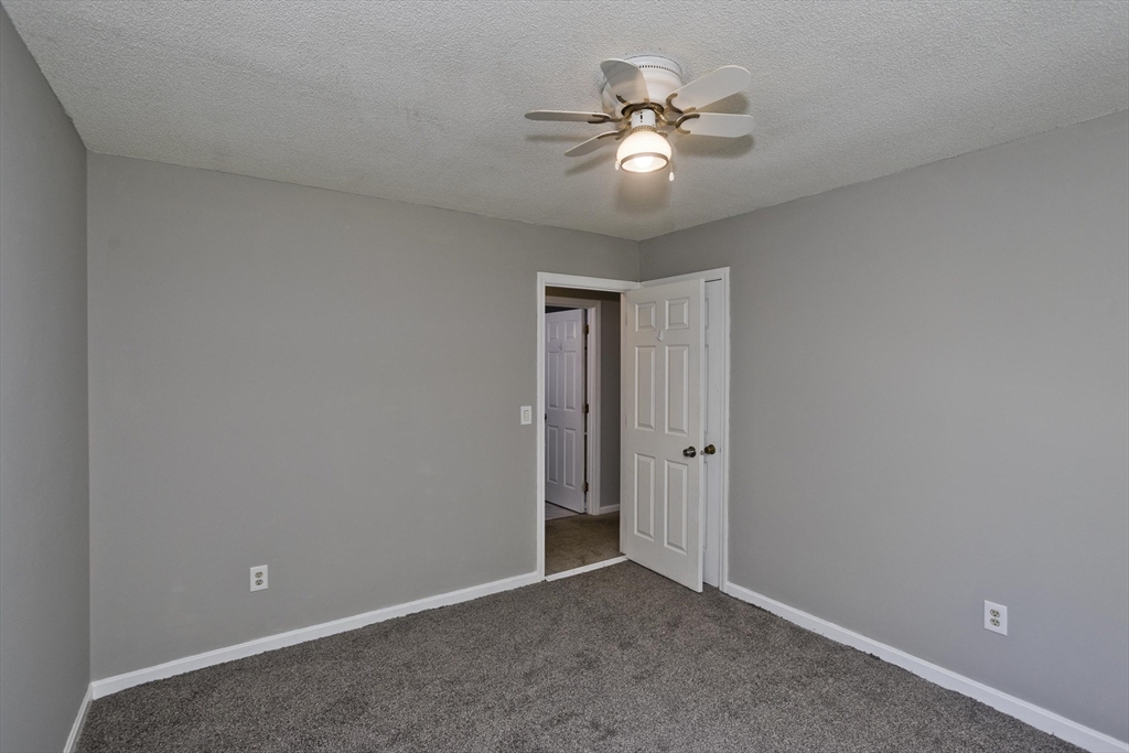 5 Michael Drive Enfield, CT 06082 - Photo 30 of 38 a view of an empty room with chandelier fan