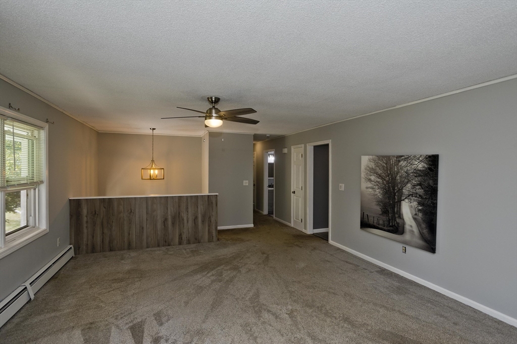 5 Michael Drive Enfield, CT 06082 - Photo 8 of 38 an empty room with windows cabinet and front door