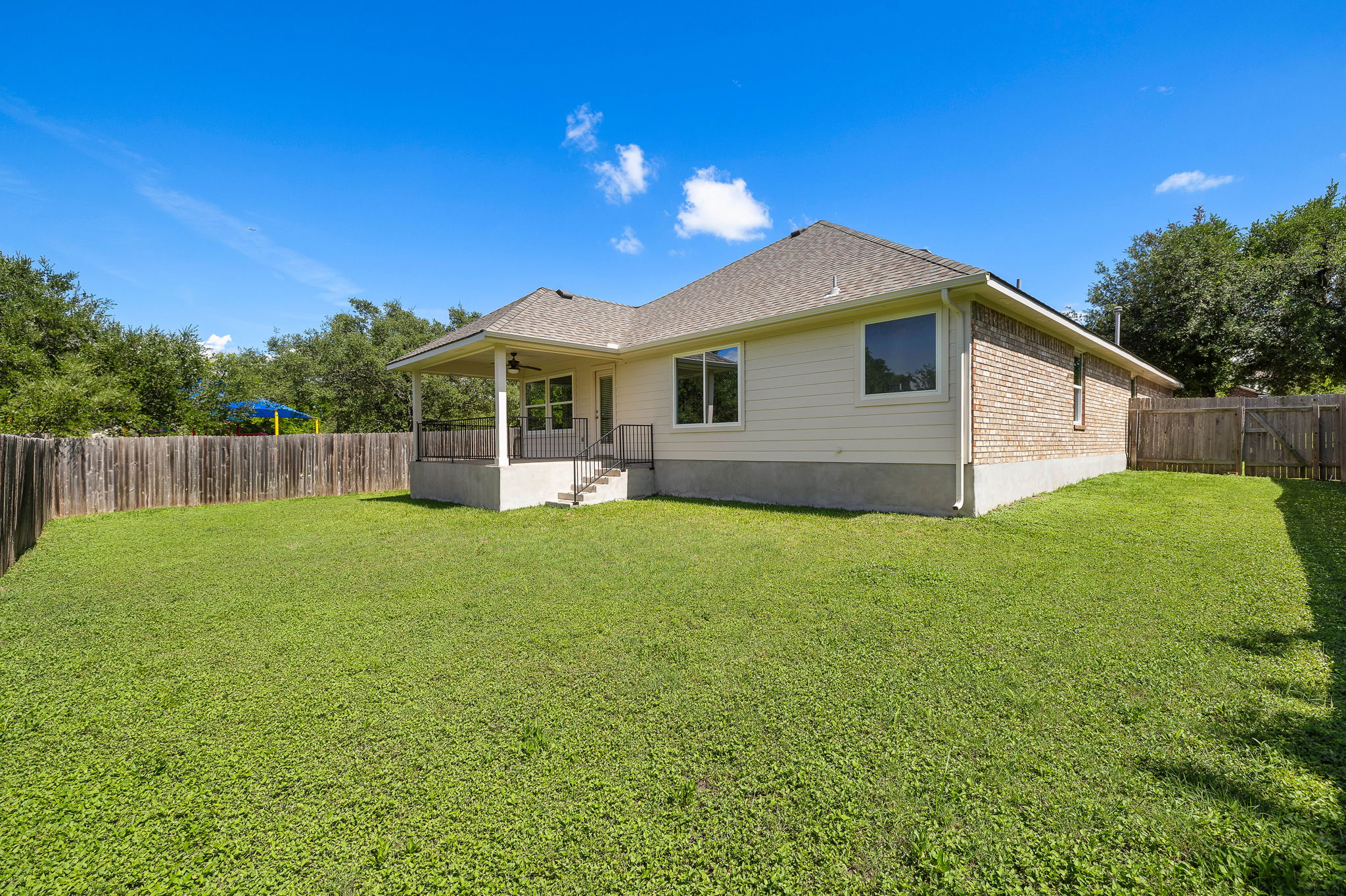 1100 Springbrook Road Pflugerville, TX 78660 - Photo 21 of 23 A fenced, well-kept backyard with a covered patio offers ample space for outdoor enjoyment.