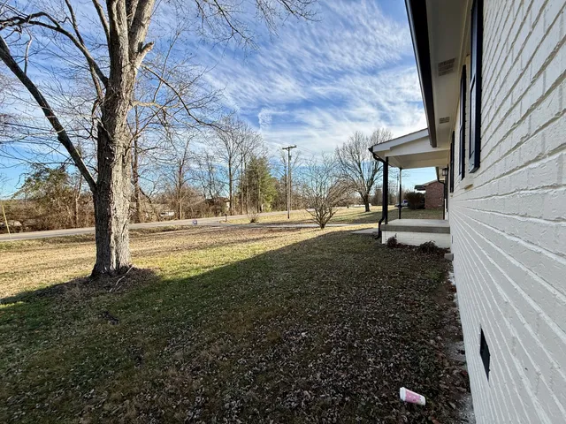 a big yard with flowing stream of water in front of it