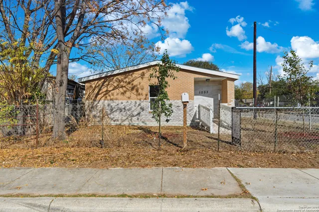 a view of a house with a small yard