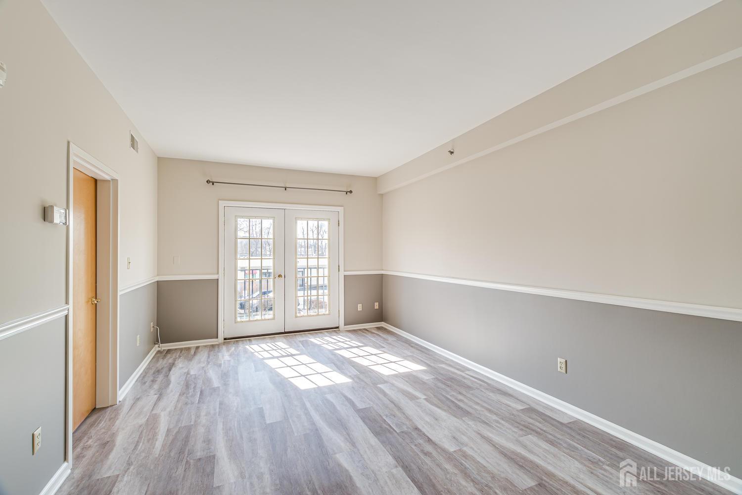 160 Durham Avenue, Unit 305 Metuchen, NJ 08840 - Photo 14 of 39 an empty room with wooden floor and windows