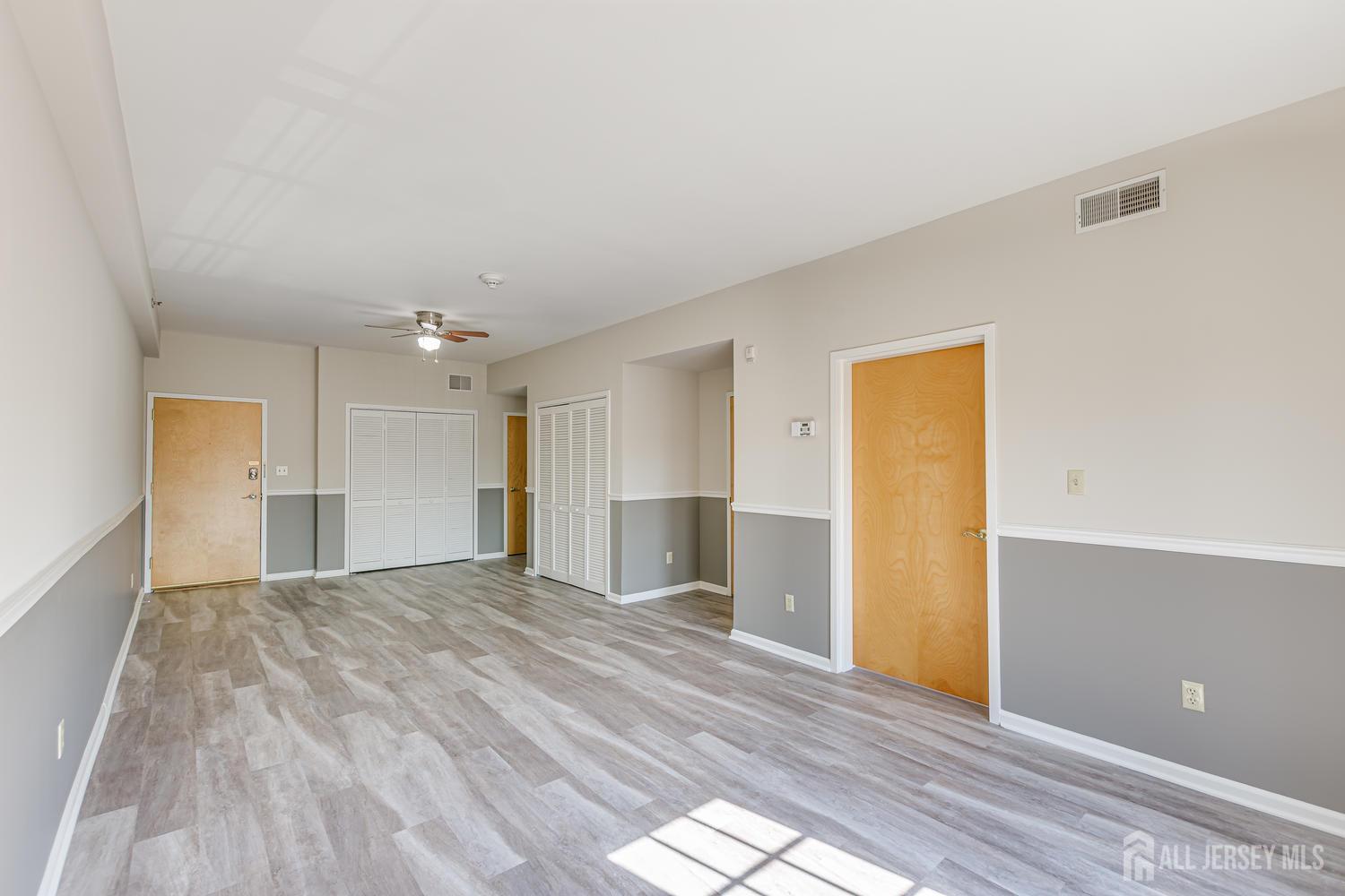 160 Durham Avenue, Unit 305 Metuchen, NJ 08840 - Photo 16 of 39 a view of a livingroom with wooden floor and a cabinet