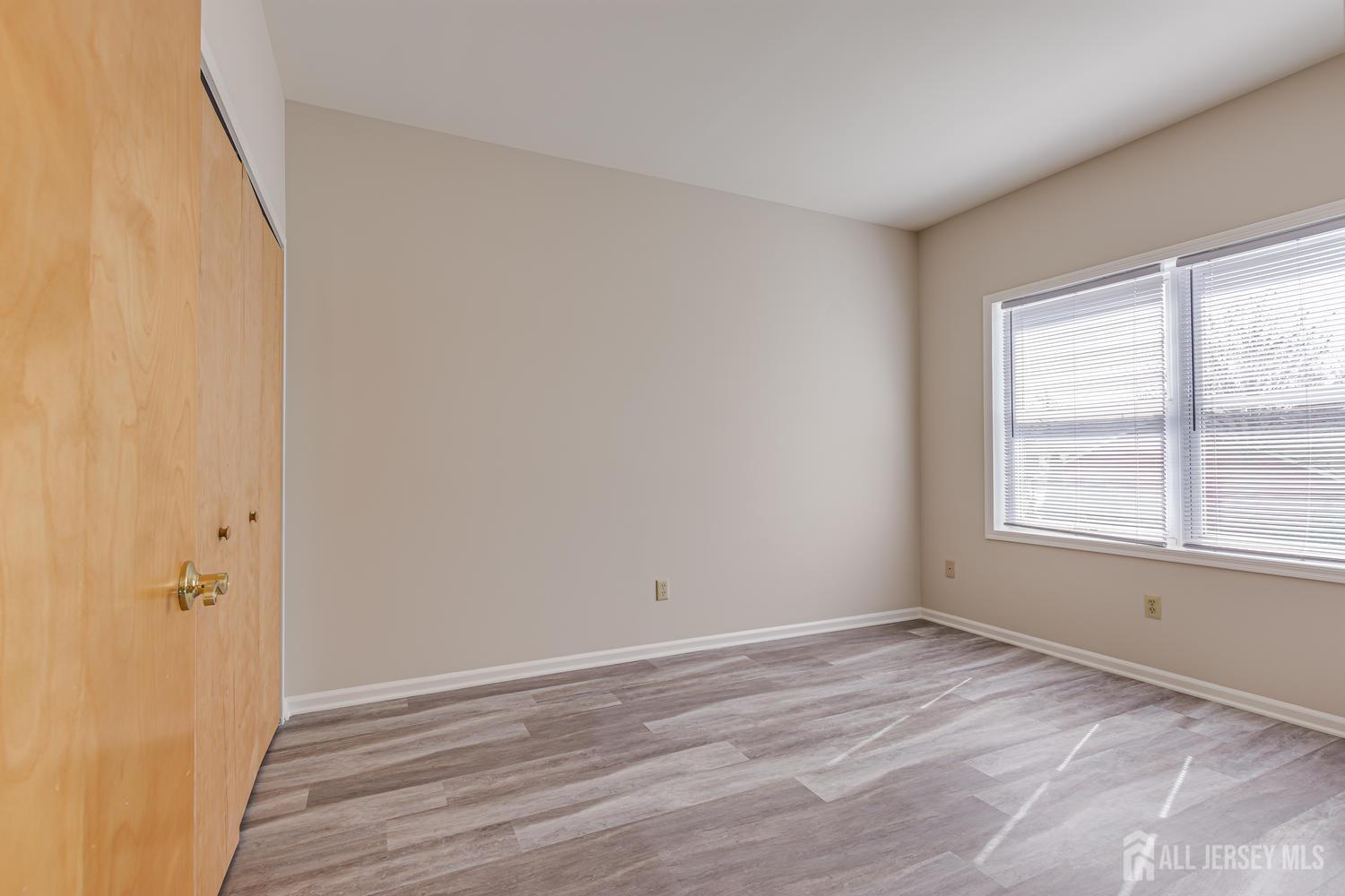 160 Durham Avenue, Unit 305 Metuchen, NJ 08840 - Photo 17 of 39 an empty room with wooden floor and window