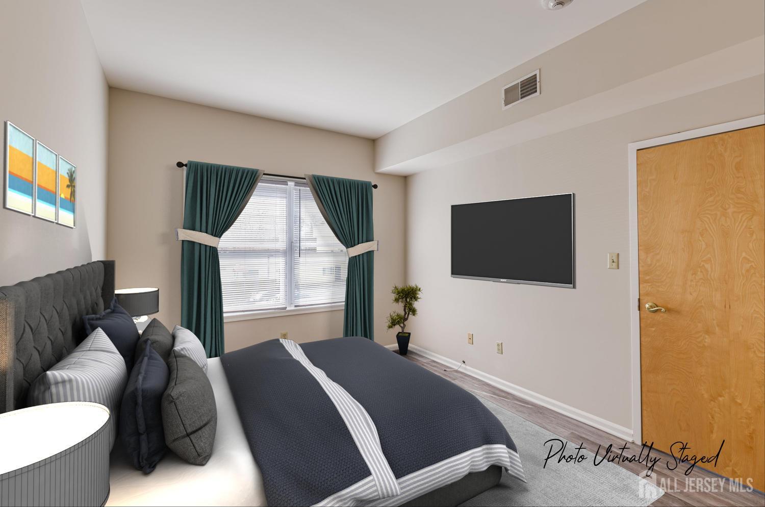 160 Durham Avenue, Unit 305 Metuchen, NJ 08840 - Photo 19 of 39 a bedroom with a bed and a flat screen tv